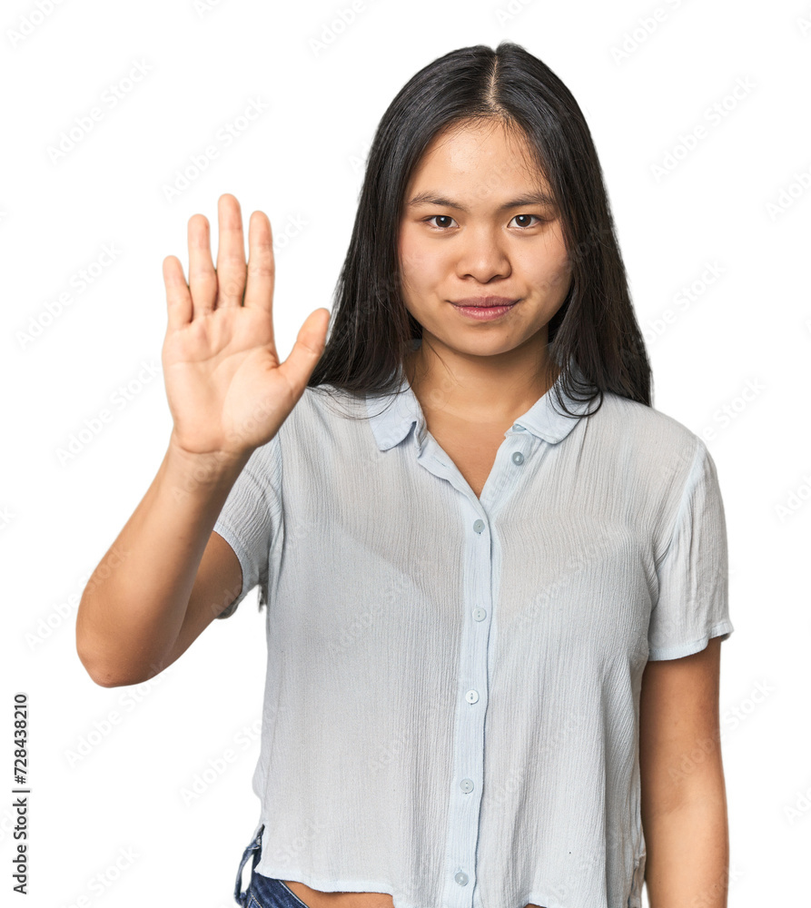 Young chinese woman isolated smiling cheerful showing number five with fingers. Young chinese woman isolated smiling cheerful showing number five with fingers.
