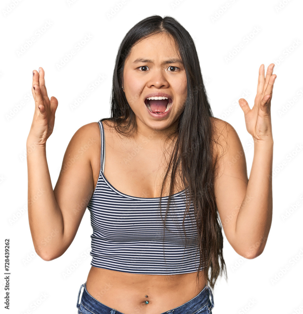 Young Chinese woman in gray top, studio screaming to the sky, looking up, frustrated. Young Chinese woman in gray top, studio screaming to the sky, looking up, frustrated.