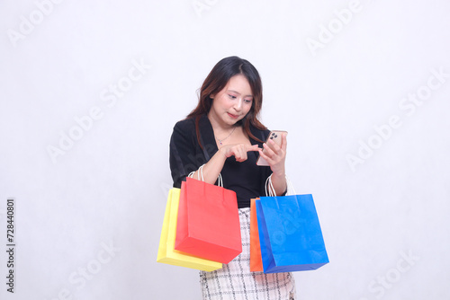 Customer, beautiful Asian girl 20s, formal office, thin smile, oblique to the left, order via cellphone, bring shopping paper bag isolated on white background