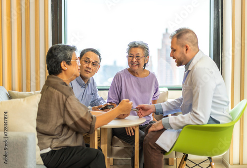 Man doctor with stethoscope service help support discussing and consulting care talk to group sick senior asian patient in hospital,caregiver,elderly,recovery,illness insurance.healthcare and medicine