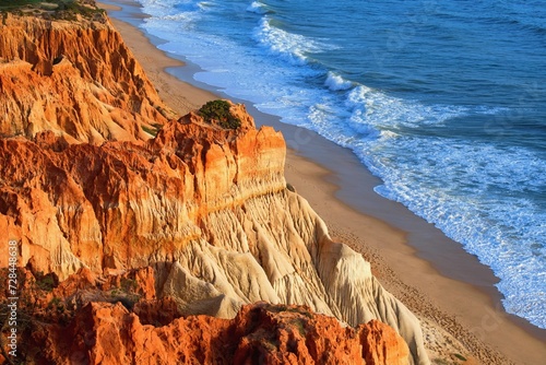Coastal cliffs and beach Falesia in the sunset light. Algarve Portugal photo