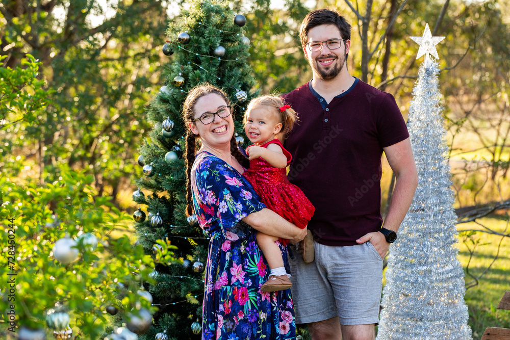 Triangle family of three laughing together at Christmas Triangle family of three laughing together at Christmas