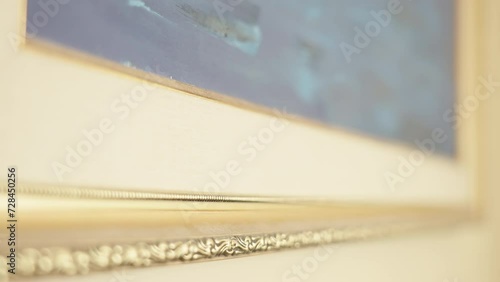 Close up of a decorative golden frame with intricate details showcasing part of a blurred painting in Tallinn on Estonia