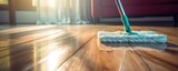 Cleaning wooden floor with mop. Household chores concept.