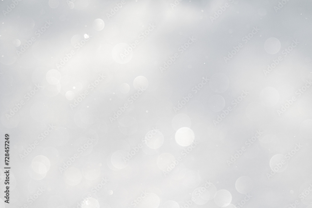 Blurred white bokeh background, snow sparkles in the sun