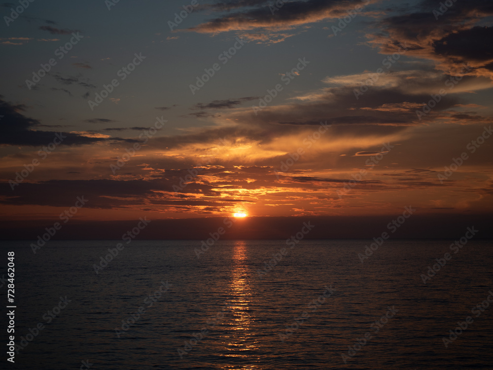 Golden Hour Serenity: Tranquil Summer Evening by the Sea with Sunset, Clouds, and Calm Waters - Peaceful Beauty of Nature, People-Free