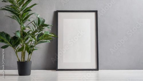 Blank vertical poster frame mock up standing on dark parquet floor next to white brick wall with vase and books. Clipping path around poster. illustration © netsay