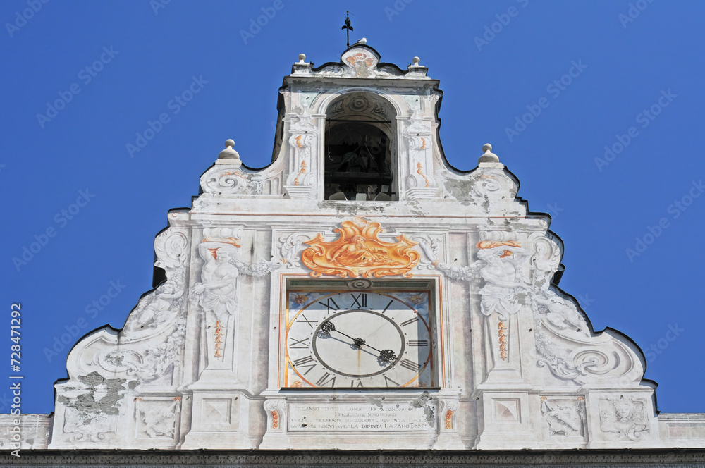 Top of the rich decorated renaissance gable of the Palazza San Giorgio or the Palace of Saint George near the port in Genoa, Italy, with clear blue sky