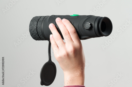 Canvas-taulu A child holds a monocular in his hand on a white background.