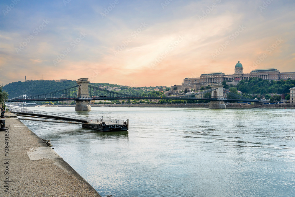 Szechenyi Chain bridge over the Danube River in the city of Budapest. Urban landscape with old buildings, St. Stephen's Basilica and opera domes. Hungary.
