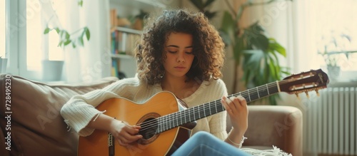 Cropped a curly young woman guitarist enjoy playing guitar in home. AI generated image