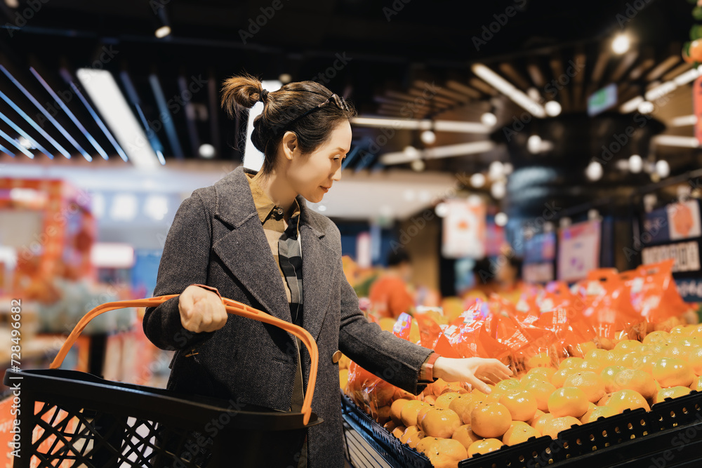 Woman Chooses Fresh Oranges in Grocery Store Woman Chooses Fresh Oranges in Grocery Store