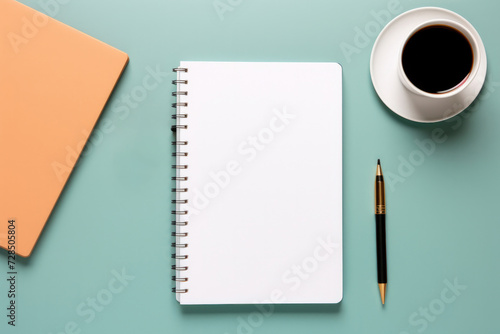 Office desk with notepad, cup of tea or coffee and other office supplies. Flat lay with copy space