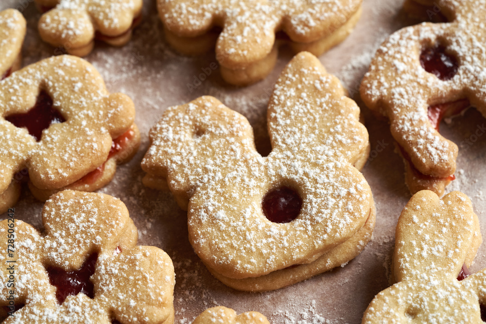 Linzer cookies in the shape of Easter chicken and bunnies filled with marmalade and dusted with sugar