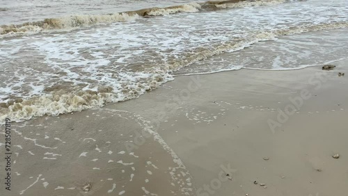 Empty beach with muddy sea water photo