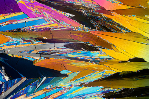 Microscopic image of erythritol sugar crystals forming a sharp-edged, colorful mosaic with a sense of movement photo