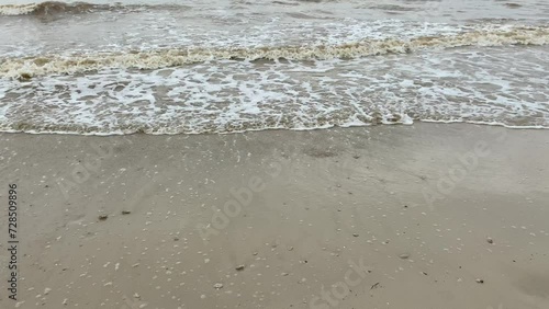 Empty beach with muddy sea water photo