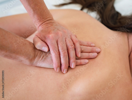 Massaging a woman in the spa