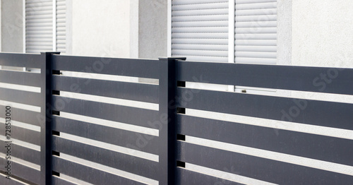 : Modern stone fence with aluminum or metal shutter 