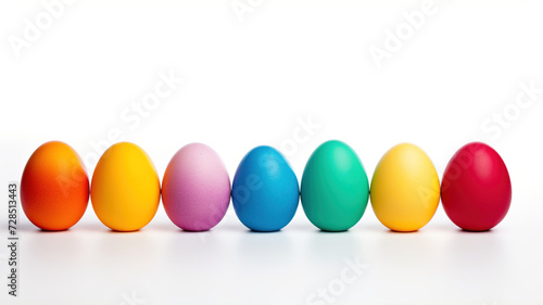 Seven Easter eggs in rainbow colors on a white background. Colorful Easter eggs isolated on white background with copy space. Chicken eggs are dyed in different colors. For postcards.