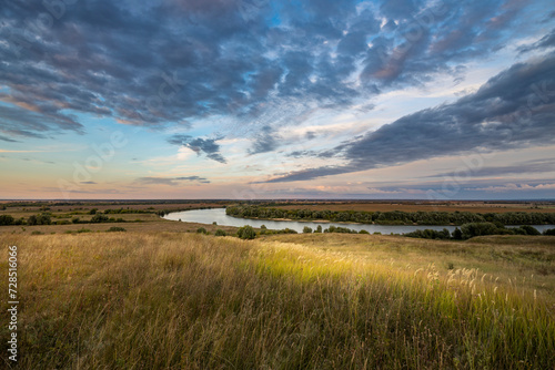 Magical autumn landscape with river and sunset sky