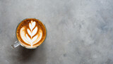 Coffee latte art in a glass on stone background, top view