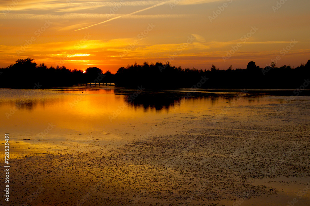 Orange sunset over the lake just before dusk