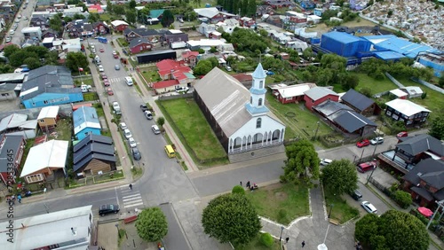 Aerial Drone Fly Above Dalcahue City Streets Chiloé Chile Patrocinio Lady Church during Daylight, Panoramic Establishing Shot photo
