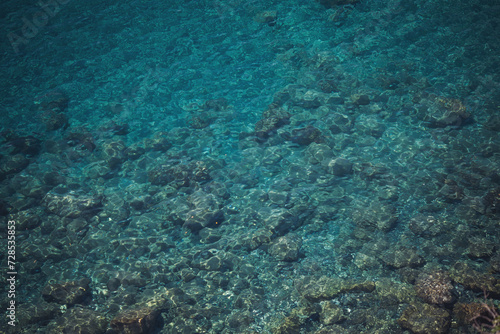 seaside. texture of the sea coast. The sea view, the rocks on the beach with turquoise sea water. Liguria , Italy. © Cristina