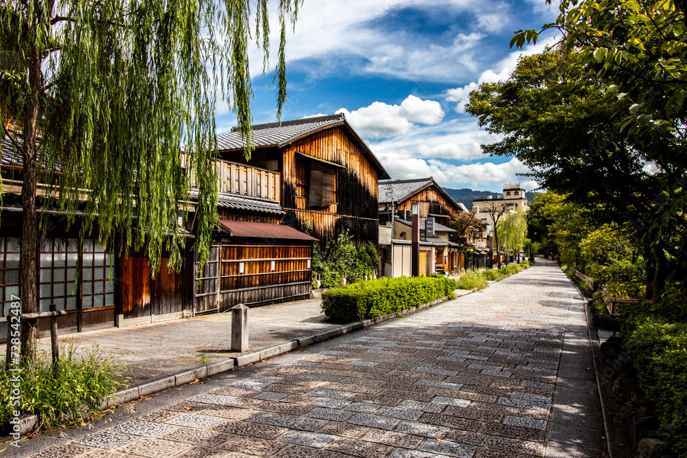Traditional wooden building burnt down on a quiet Kyoto street on a sunny summer's day. Authentic Japanese streets ans architecture, horizontal image