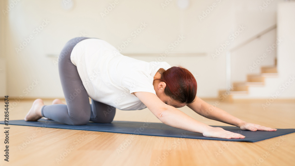 Pregnant woman is engaged in yoga. Baby asana or Balasana