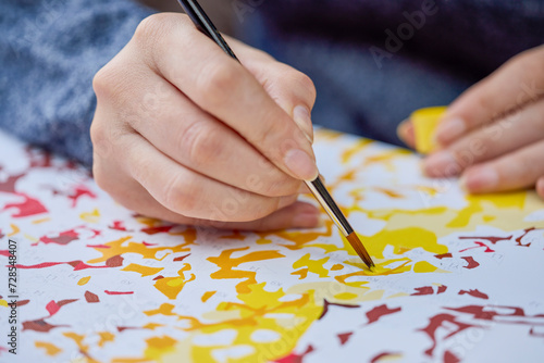 Wallpaper Mural a woman's hand holding a brush and painting on a canvas to learn to paint. Torontodigital.ca