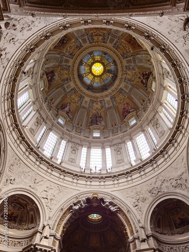 The ceiling of a large building with a dome is a grand  arched structure that rises to a peak above  providing a sense of openness and grandeur.