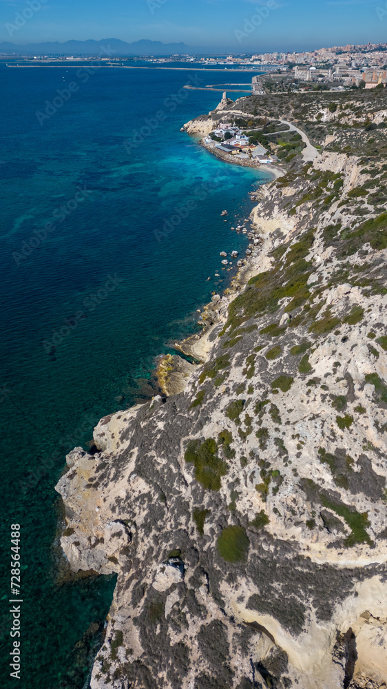 Aerial view with drone of the Sella del Diavolo in Cagliari. Sunny day, crystal clear sea with boats. Aerial view with drone of the Sella del Diavolo in Cagliari. Sunny day, crystal clear sea with boats.