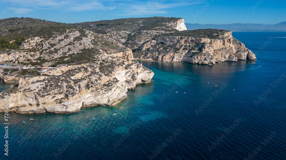 Aerial view with drone of the Sella del Diavolo in Cagliari. Sunny day, crystal clear sea with boats. Aerial view with drone of the Sella del Diavolo in Cagliari. Sunny day, crystal clear sea with boats.
