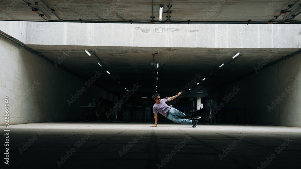 Group of attractive asian hipster practice break dancer at building. Stylish dancer wearing stylish cloth while doing freeze pose. Freestyle dance and energetic dance. Outdoor sport 2024. Sprightly.