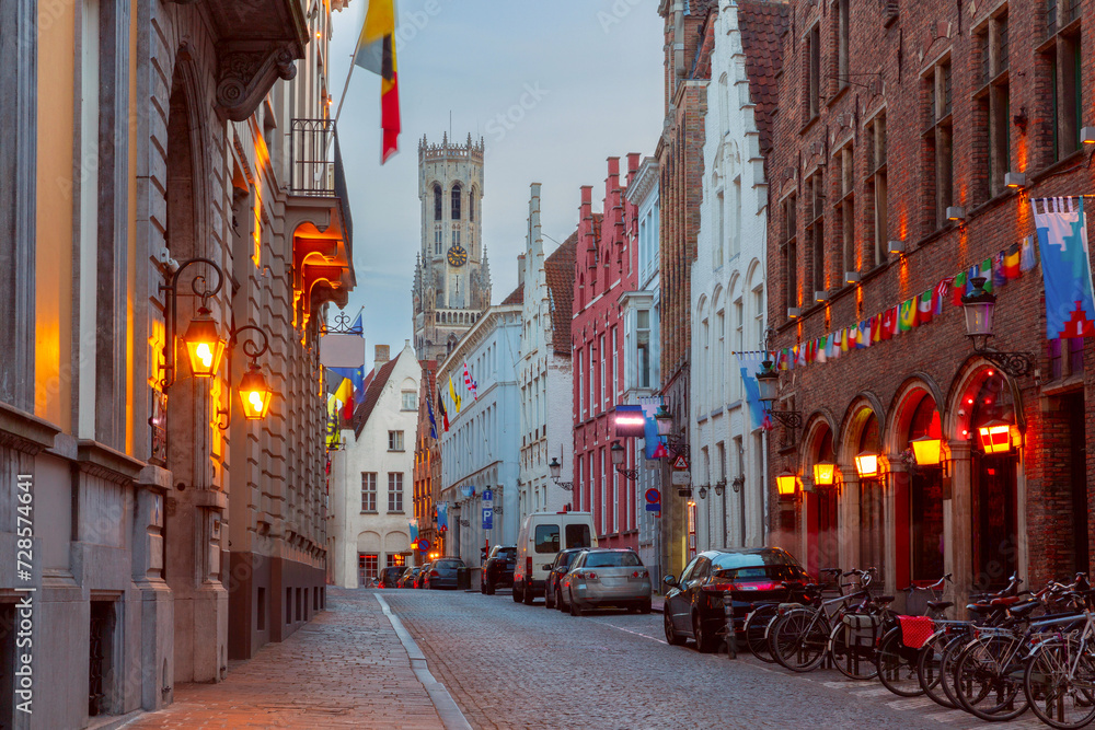 Scenic cityscape with medieval fairytale town, street and tower Belfort at night, Bruges, Belgium