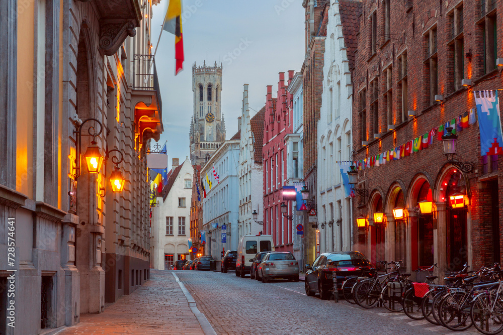 Fototapeta premium Scenic cityscape with medieval fairytale town, street and tower Belfort at night, Bruges, Belgium