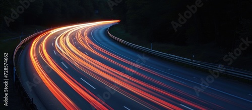 Nighttime highway scene with multiple streaks of light.