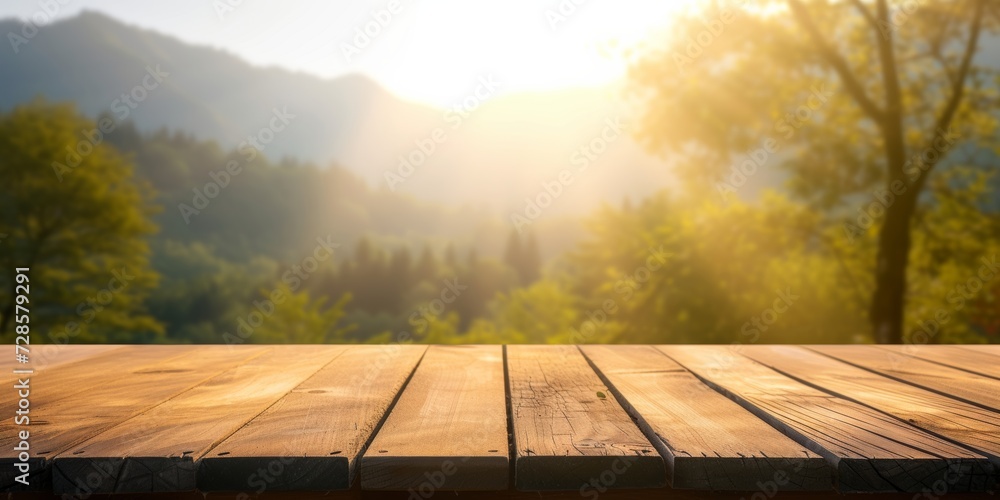 Empty wooden table top with blurred nature background. Mountain with trees in calm sunny day. Table top with copy space for product advertising