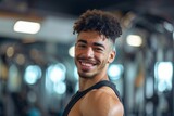 Smiling Man in Black Tank Top at the Gym
