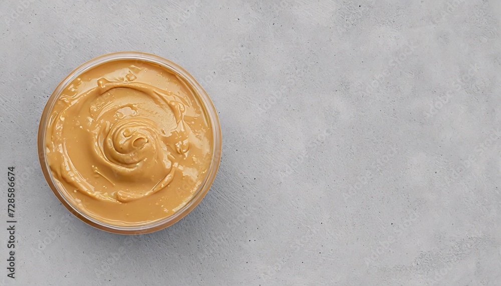 Tasty homemade peanut paste in bowl. Smooth and creamy butter texture as background. Top view Tasty homemade peanut paste in bowl. Smooth and creamy butter texture as background. Top view