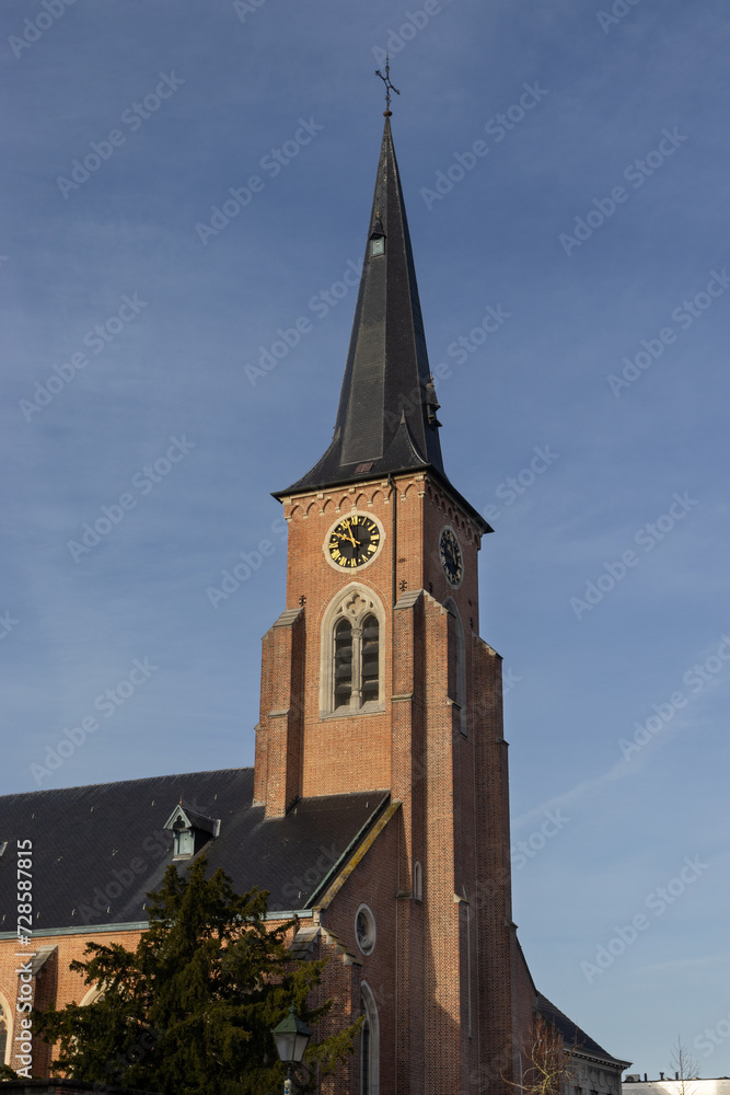 View of St. Gertrudes Church and church tower,  in Wichelen in East Flanders, Belgium, on a bright sunny morning.