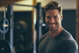 Smiling Man in Gym With Barbell in Background
