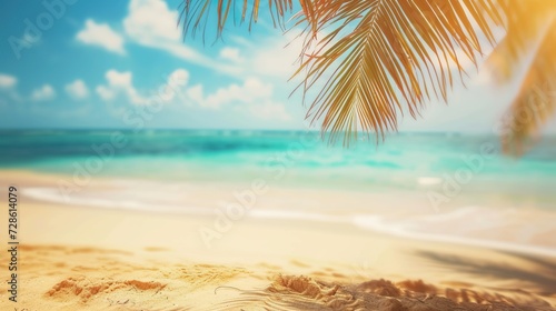 Blurred beach scene background. Golden sand, turquoise water, and a soft clouds sky, framed by the silhouetted fronds of an overhanging palm tree.