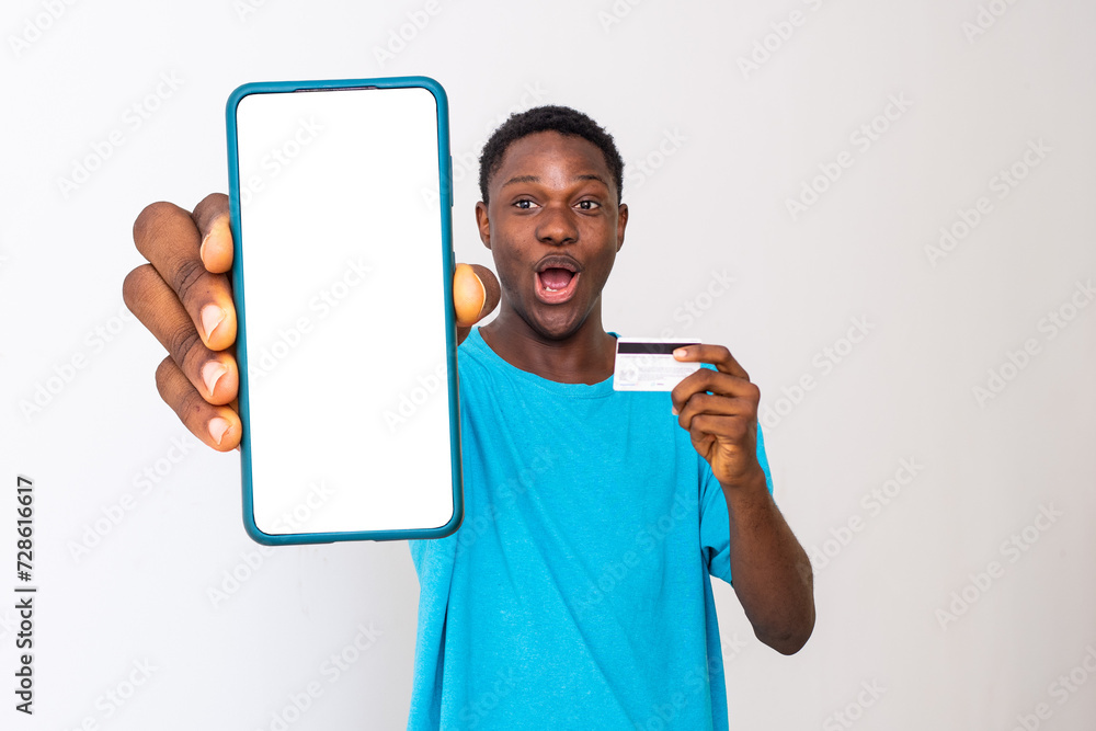 man showing phone screen and holding credit card man showing phone screen and holding credit card