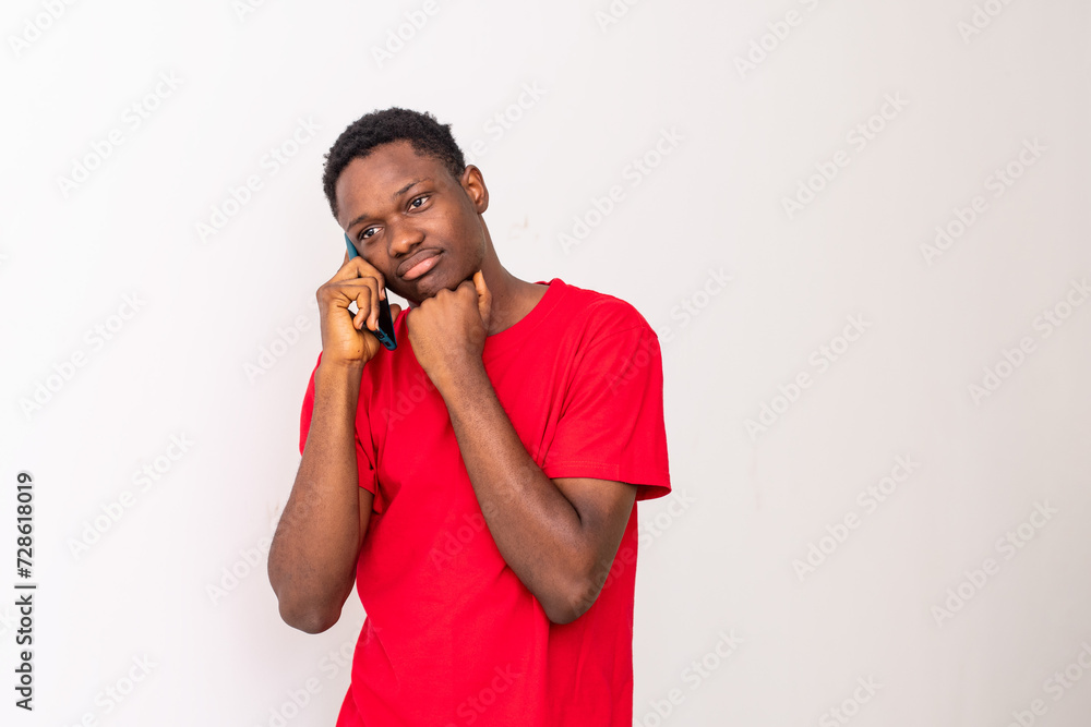 young black man making a phone call looking worried young black man making a phone call looking worried