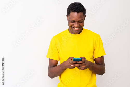 smiling young black man checking his smartphone © Confidence