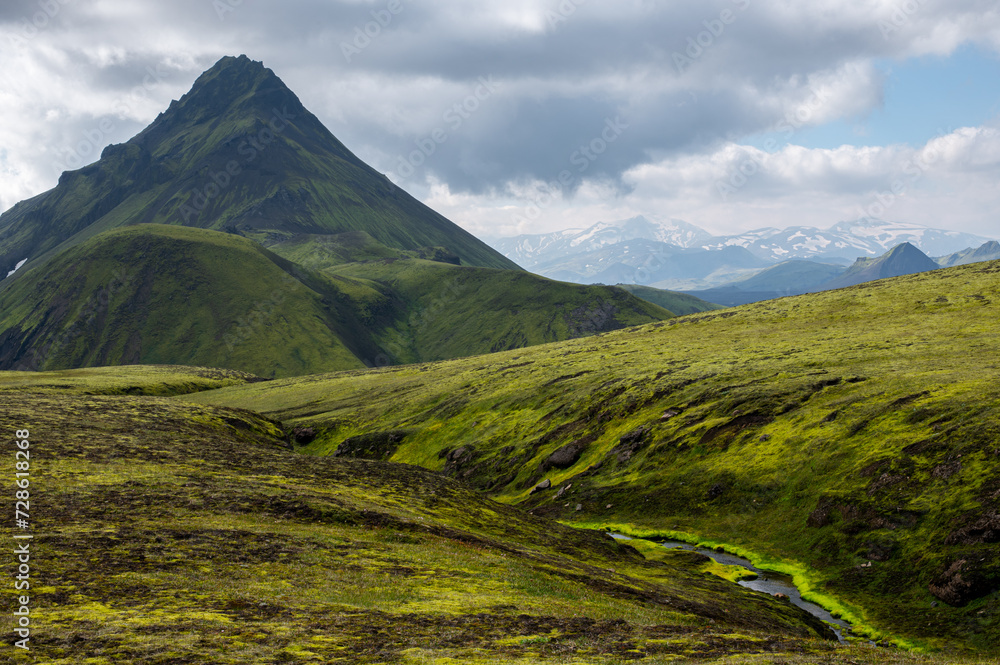 Fototapeta premium Amazing Icelandic landscape with mountains, river and field on a sunny day at famous Laugavegur hiking trail, South Iceland. Acid colours landscape.
