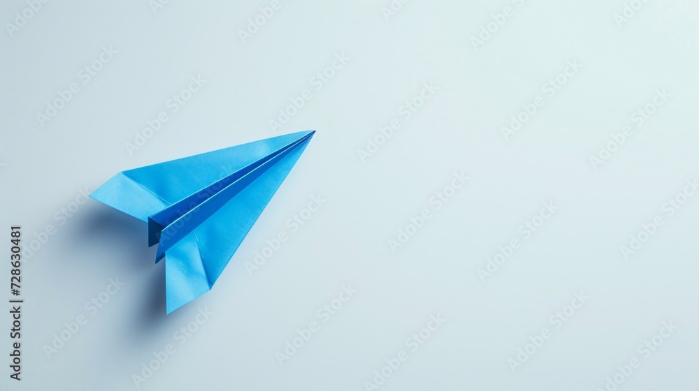 Blue paper plane against a white background Blue paper plane against a white background